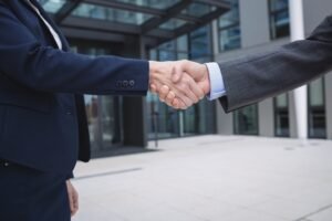 businesspeople-shaking-hands-scaled